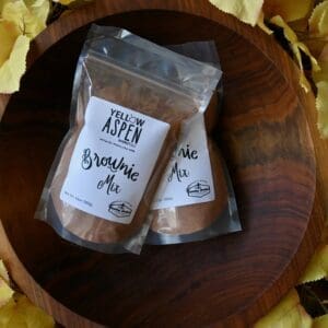 Brownie mix in wooden bowl with leaves.