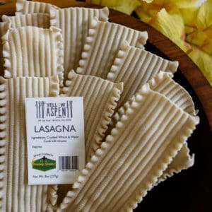 Lasagna noodles with yellow leaves background.